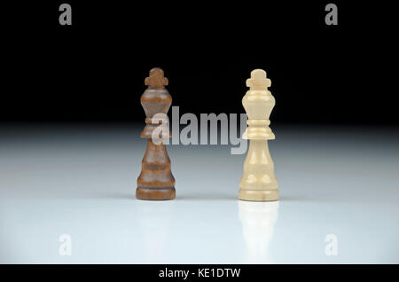 Close-up view of two chess king on blurred black and white background with reflection Stock Photo