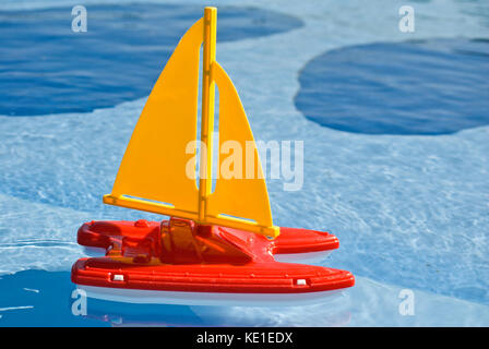 plastic toy sailboat in swimming or pool Stock Photo