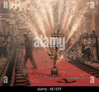 Fire on street decorated with coloured salt during Fiesta del Carmen celebrations. La Isleta, Las Palmas, Gran Canaria, Canary Islands, Spain Stock Photo