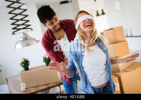 home, people, moving and real estate concept - couple in love moving in Stock Photo