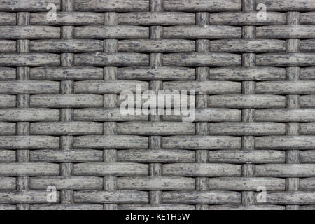 Full frame background texture of grey dyed natural rattan weave, creating a rustic woven wicker pattern Stock Photo