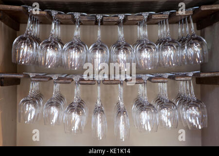 A rack holding wine glasses in a pub in Wiltshire, England. Stock Photo