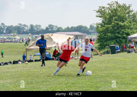 American high school teenage girls playing soccer in a game tournament Stock Photo