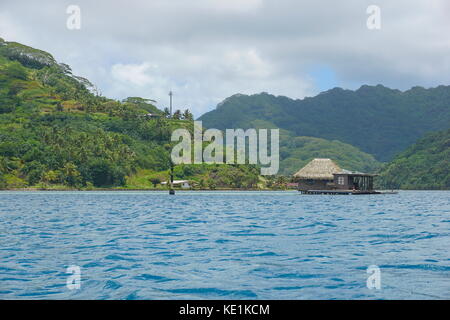 French Polynesia Huahine island coastline with a pearl oyster farm over the water in the lagoon, Faie, south Pacific ocean Stock Photo