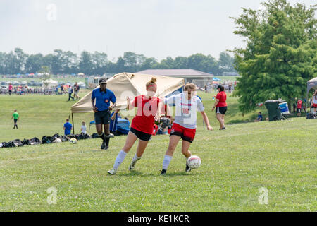 American high school teenage girls playing soccer in a game tournament Stock Photo