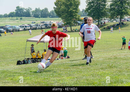 American high school teenage girls playing soccer in a game tournament Stock Photo