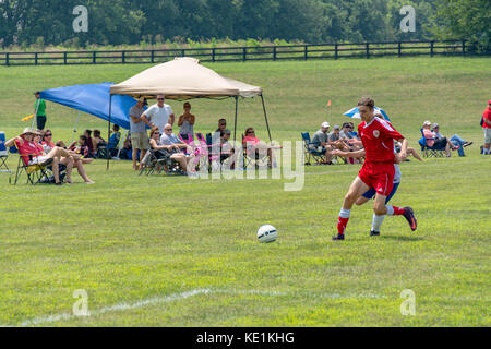 American high school teenage boys playing soccer in a game tournament Stock Photo