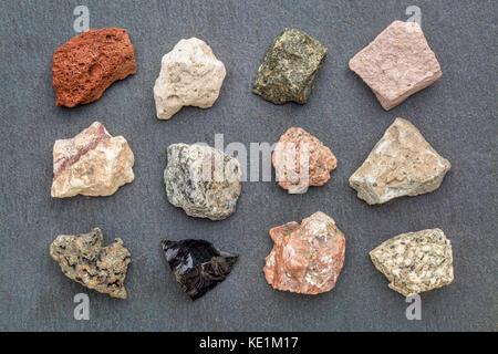 igneous rock geology collection, from top left: scoria, pumice, gabbro, tuff, rhyolite, diorite, granite, andesite, basalt, obsidian,  pegmatite, porp