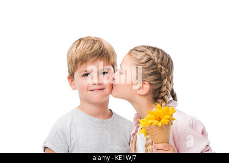 adorable little girl holding waffle cone with flowers and kissing cute boy isolated on white Stock Photo