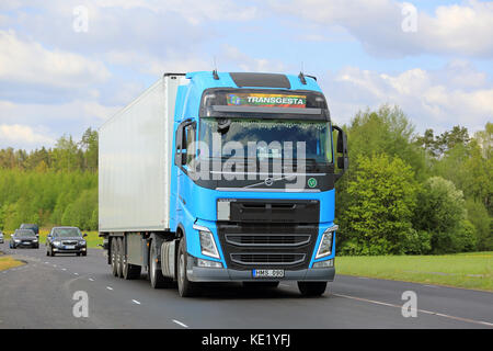 SALO, FINLAND - MAY 20, 2016: Sky blue Volvo FH semi truck among traffic on a rural highway in South of Finland. Stock Photo