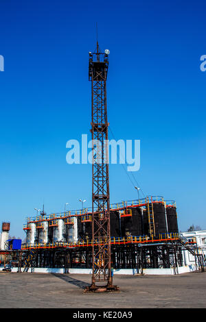 Old and rusty lighting tower at an oil refinery in Russia Stock Photo