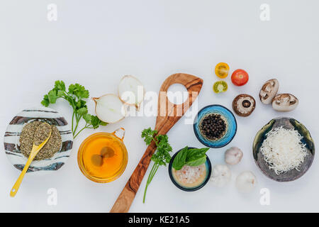 Various vegetable and ingredients for cooking pasta menu sweet basil ,tomato ,garlic ,extra virgin olive oil ,parsley  and champignon setup on white w Stock Photo