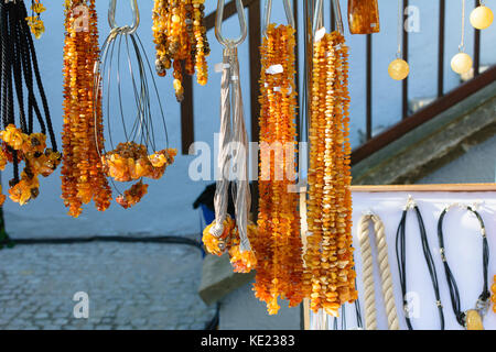 Typical amber jewelery sold at a stand in the Old Town of Gdansk. Stock Photo