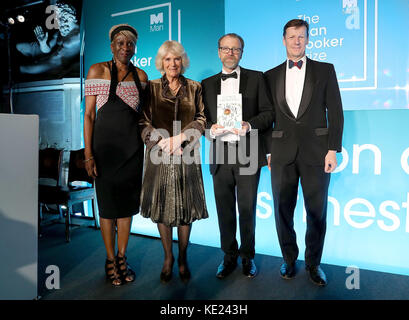 (Left-right) Baroness Lola Young, the Duchess of Cornwall, winning author George Saunders and Man Group CEO Luke Ellis on stage at the Guildhall in London, during the 2017 Man Booker award ceremony. Stock Photo