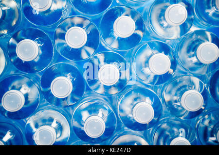 High angle view of plastic water bottles in a row. Concept of industrial production, recycling, disposal of waste, and environmental conservation. Stock Photo