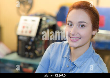 female engineer operating cnc machinery Stock Photo
