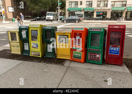 Row of free newspaper dispensers on the Upper East Side of Manhattan, NY. Stock Photo