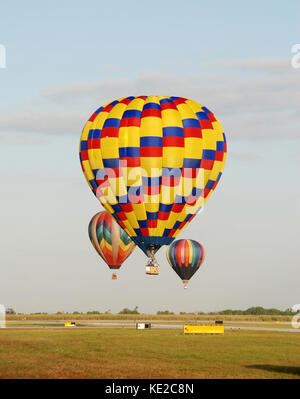 Big colorful hot air balloons flying high in the blue cloudy sky during ...