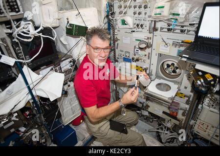 International Space Station Expedition 53 Italian astronaut Paolo Nespoli runs his blood through the Human Research Facility-2's refrigerated centrifuge October 17, 2017 in Earth Orbit. Stock Photo