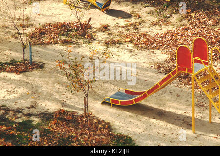 Children's slide at yard autumn playground. Top view. Stock Photo