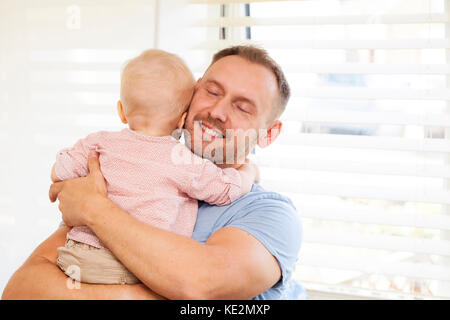 Dad holding his one year old baby son Stock Photo