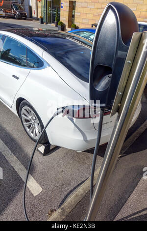 Tesla electric cars at charging point, Manchester Stock Photo