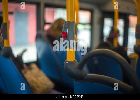 stop button on hand rail public bus London England Stock Photo