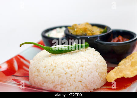 Indian Gee rice with complete curry meal served on a tray in a restaurant Stock Photo