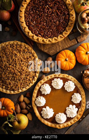 Fall traditional pies pumpkin, pecan and apple crumble pie overhead shot Stock Photo
