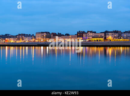 Margate seafront on the Kent coast, reflected in the bathing pool at dusk. Stock Photo
