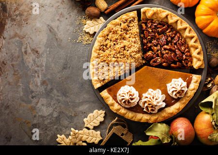 Fall traditional pies pumpkin, pecan and apple crumble Stock Photo