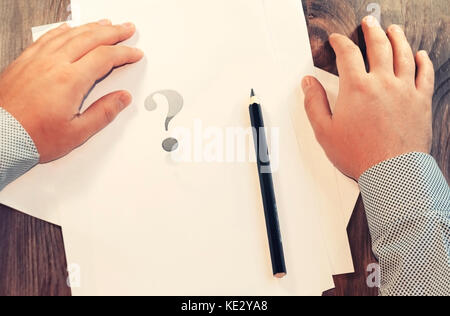 Question mark in front of a man. The concept of a decision or choice. Symbol. Stock Photo