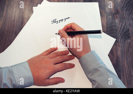 A sheet of paper in front of a man with the words: My gap year . Planning of affairs for the year. The concept. Stock Photo