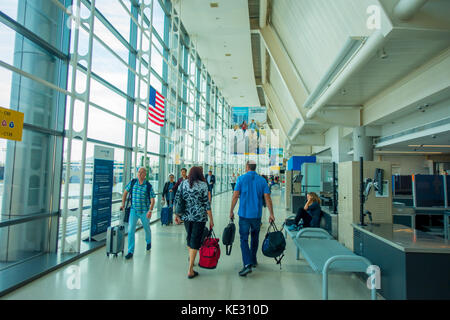 NEWARK, NJ - OCTOBER 16, 2017: Unidentified people walking at Newark Airport interior in Newark, New Jersey. Newark airport near New York City is 10th busiest in US and the 2nd-largest hub for Continental Airlines Stock Photo