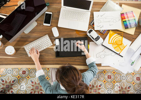 High angle view of young female car designer at work Stock Photo