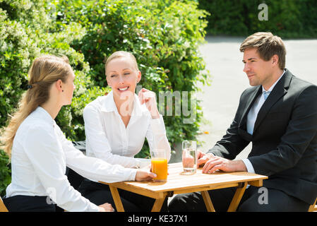 Group Of Young Happy Businesspeople Having Break From Work Stock Photo