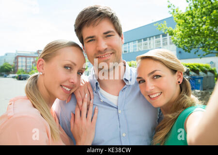 Group Of Young Happy Male And Female Friends Taking Selfie Stock Photo