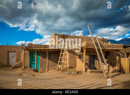 Taos Pueblo (or Pueblo de Taos) in New Mexico is an ancient pueblo belonging to a Tiwa-speaking Native American tribe of Puebloan people. Stock Photo