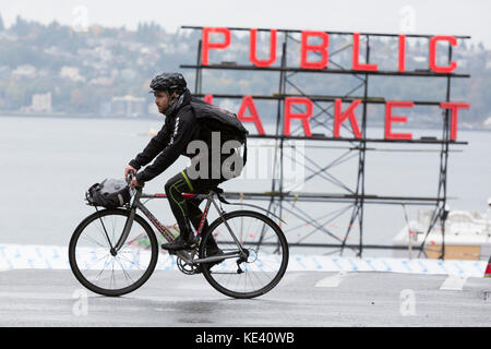 Seattle, United States. 18th Oct, 2017. Seattle, Washington: Cyclist crosses Pine street as the first storm of the season lashes Seattle with high winds and rain. The National Weather Service has a high wind warning in effect and a heavy rainfall advisory through the weekend for most of Western Washington. Credit: Paul Christian Gordon/Alamy Live News Stock Photo