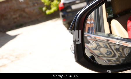 Blind Spot Monitoring system warning light icon in side view mirror of a modern vehicle. system blind spots of the car Stock Photo