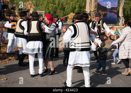 CLUJ NAPOCA, ROMANIA - OCTOBER 15, 2017: Romanian folk dancers performing a dance in traditional costumes in the Autumn Fair Stock Photo
