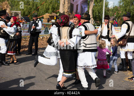 CLUJ NAPOCA, ROMANIA - OCTOBER 15, 2017: Romanian folk dancers performing a dance in traditional clothes in the Autumn Fair Stock Photo