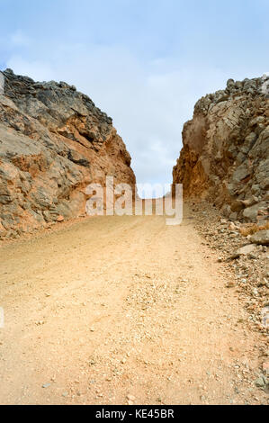 Dirt road dug in the hill in the mountains on the island of Crete Stock Photo