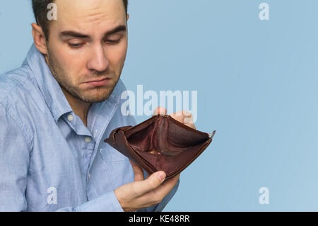 Man with no money. Businessman holding empty wallet. Man showing empty wallet by showing the inconsistency and lack of money and not able to pay the l Stock Photo