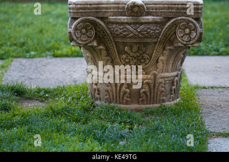 Column capital on earth Museum exhibit Stock Photo - Alamy