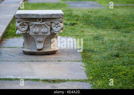 Column capital on earth Museum exhibit Stock Photo - Alamy