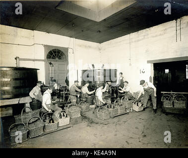 Workers filling and corking wine bottles at the American Wine Company Stock Photo