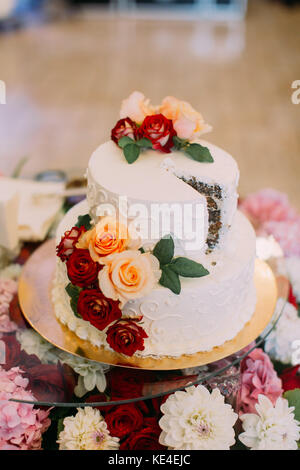 Close-up view of the wedding cake decorated with colourful roses. Stock Photo