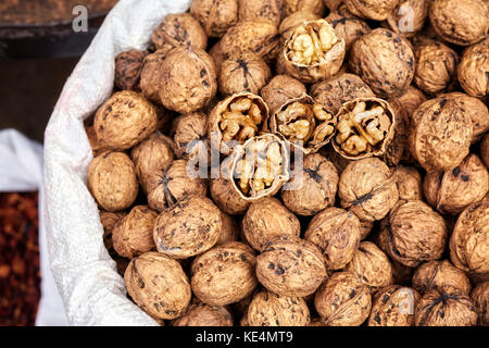 Close up picture of walnuts in a bag on a local market, selective focus. Stock Photo