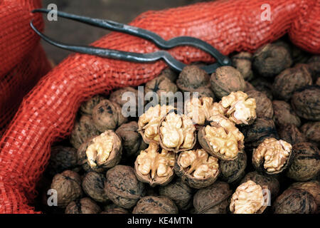 Close up picture of walnuts in a bag on a local market, selective focus. Stock Photo